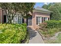 Elegant entryway with decorative door, stone pathway, and lush landscaping at 18800 Boundary Oaks Ct, Davidson, NC 28036