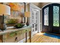 Welcoming foyer showcasing hardwood floors, stylish console table, and decorative lighting at 18800 Boundary Oaks Ct, Davidson, NC 28036