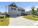 Charming two-story home featuring a spacious driveway and a well-maintained front lawn at 2097 Saddlebred Dr, Iron Station, NC 28080