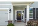 Close-up of a charming front door with sidelights, decorative wreath, and address number at 2097 Saddlebred Dr, Iron Station, NC 28080