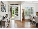 Bright foyer with hardwood floors, showcasing the entryway and adjacent dining area at 221 N Centurion Ln, Mount Holly, NC 28120