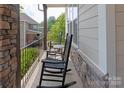 Inviting porch with comfortable rocking chairs, perfect for relaxing outdoors at 221 N Centurion Ln, Mount Holly, NC 28120