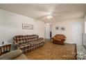 Comfortable living room featuring traditional decor, ceiling fan, and ample natural light at 2694 Rock Dam Rd, Lincolnton, NC 28092