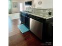 Kitchen island with granite countertops, stainless steel appliances, and hardwood floors at 2769 Sawbridge Ln, Gastonia, NC 28056