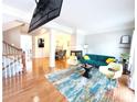 Open-concept living room features hardwood floors, stylish furnishings, and a fireplace at 3114 Luke Crossing Dr, Charlotte, NC 28226