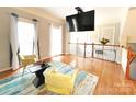Cozy living area with hardwood floors, a colorful rug, and plenty of natural light at 3114 Luke Crossing Dr, Charlotte, NC 28226