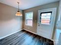 Cozy breakfast nook featuring wood floors, a door to the backyard, and natural light at 4754 Old Lantern Way, Charlotte, NC 28212