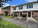 Street view of well-maintained townhomes with brick facades, neat landscaping, and inviting walkways at 4754 Old Lantern Way, Charlotte, NC 28212
