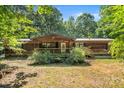 Exterior shot of a cozy wooden home with a front porch and mature landscaping at 5212 Timber Creek Ct, Kings Mountain, NC 28086