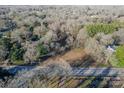 Scenic aerial view of a residential neighborhood nestled among lush trees and a road at 529 Winding Way Way # 8, Belmont, NC 28012