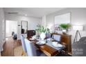 Well-appointed dining area with seating for six, hardwood floors, and stylish decor at 668 14Th Avenue Ne Ct, Hickory, NC 28601