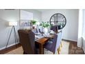 Cozy dining room features hardwood floors, a wooden table set for six, and modern decor at 668 14Th Avenue Ne Ct, Hickory, NC 28601