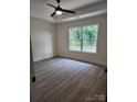 Comfortable bedroom boasts neutral walls, sleek floors, natural light, and a ceiling fan at 723 Taylor St, Rock Hill, SC 29730