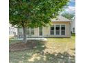 Backyard featuring a concrete patio, lawn, light siding, and large windows at 7406 Carolina Jessamine Ct, Indian Land, SC 29707