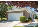 Charming single-Gathering home featuring a brick facade, well-manicured lawn, and attached two-car garage at 7406 Carolina Jessamine Ct, Indian Land, SC 29707