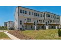 New construction townhome backyard featuring a private patio for outdoor relaxation and entertaining at 9212 Delancey Ln # 63, Concord, NC 28027
