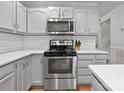 Well-lit kitchen featuring stainless steel oven, white countertops, and subway tile backsplash at 9214 Arbourgate Meadows Ln, Charlotte, NC 28277