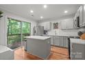 Bright kitchen with an island, stainless steel appliances, and sliding door to deck at 9214 Arbourgate Meadows Ln, Charlotte, NC 28277