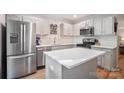 Spacious kitchen boasts stainless steel appliances, quartz countertops, and center island at 9214 Arbourgate Meadows Ln, Charlotte, NC 28277