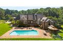 Expansive backyard featuring a pool, patio, and well-maintained landscaping perfect for outdoor entertaining at 929 Blacksnake Rd, Stanley, NC 28164