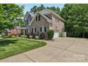 Beautiful brick home with an attached garage and a well-maintained lawn and driveway at 9735 Devonshire Dr, Huntersville, NC 28078