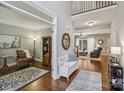 Open-concept foyer leading to the living room, study, and stairs, showcasing hardwood floors at 9735 Devonshire Dr, Huntersville, NC 28078