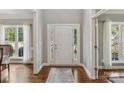 Welcoming foyer with hardwood floors, a white door, and sidelights, offering an elegant entrance at 9735 Devonshire Dr, Huntersville, NC 28078