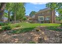 Expansive backyard with lush greenery and patio, perfect for outdoor entertaining and relaxation at 10500 Kilmory Ter, Charlotte, NC 28210