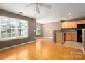 Open-concept living room with hardwood floors, dining area, kitchen, and natural light at 10613 Prairie Ridge Ln, Charlotte, NC 28213