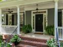 Close up of the home's covered front porch with elegant columns and a welcoming entrance at 15628 Waterfront Dr, Huntersville, NC 28078