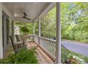 Relaxing front porch with ceiling fan and rocking chairs overlooking a peaceful street at 15628 Waterfront Dr, Huntersville, NC 28078