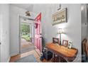 Bright entryway featuring a red door, wooden floors, and decorative accents at 1668 Tate Rd, Rock Hill, SC 29732