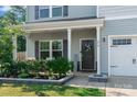 Inviting front porch with decorative wreath, seating area, and manicured landscaping for curb appeal at 210 Clove Hitch Dr, Statesville, NC 28677
