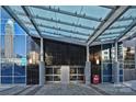 Modern building entrance featuring a glass canopy and valet parking at 222 S Caldwell St # 1812, Charlotte, NC 28202