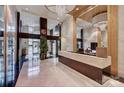 Spacious building lobby featuring marble floors, modern lighting, and a reception desk at 222 S Caldwell St # 1812, Charlotte, NC 28202