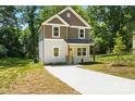 Well-manicured front yard showcases this two-story home's clean lines and newly poured concrete driveway at 2732 Mayfair Ave, Charlotte, NC 28208