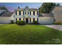 Charming two-story home at dusk with black shutters, tidy landscaping, and a well-manicured green lawn at 3702 Arthur St, Indian Trail, NC 28079