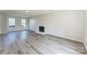 Bright living room featuring modern fireplace, grey floors and two large windows providing natural light at 3702 Arthur St, Indian Trail, NC 28079