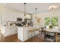 Modern kitchen with white cabinets, stainless steel appliances, and an island with seating at 5328 Oaktree Dr, Gastonia, NC 28052