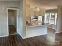 Bright kitchen featuring white cabinetry, a breakfast bar, and views into the dining area at 6218 Old Pageland Marshville Rd, Marshville, NC 28103