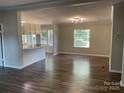 Open-concept living room and kitchen featuring modern flooring, ample natural light, and neutral decor at 6218 Old Pageland Marshville Rd, Marshville, NC 28103