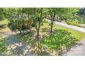 Aerial shot of a home with mature trees, a long driveway, and a spacious, grassy yard at 6616 Woodlawn Ln, Indian Trail, NC 28079