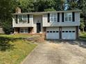 Charming two-story home with an attached two-car garage and a well-maintained lawn at 707 Regency Dr, Charlotte, NC 28211