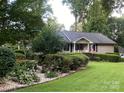 A charming home with beautiful landscaping and a well-maintained lawn at 1047 Honeybee Trl, Fort Mill, SC 29715