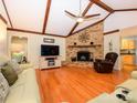 Inviting living room features vaulted ceilings with wood beams and a brick fireplace at 1047 Honeybee Trl, Fort Mill, SC 29715
