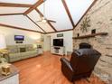 Inviting living room features vaulted ceilings with wood beams and a brick fireplace at 1047 Honeybee Trl, Fort Mill, SC 29715