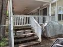 Exterior view of home featuring wooden steps leading to a cozy covered front porch at 111/113 Shawnee Trl # D140/141, Mount Gilead, NC 27306