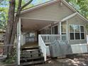 Exterior view of home featuring wooden steps leading to a cozy covered front porch at 111/113 Shawnee Trl # D140/141, Mount Gilead, NC 27306