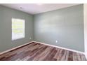 Bedroom featuring hardwood flooring, a neutral paint color, and a bright window at 1542 Antioch Dr, Conover, NC 28613