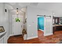 Bright foyer with hardwood floors, a barn door, and easy access to the kitchen at 1774 Timmons Marie Ln, Lincolnton, NC 28092